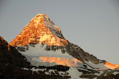 
Bright Orange Light Of Sunrise On Mount Assiniboine And Glacier Below Summit From Lake Magog
